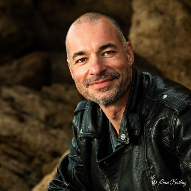 A handsom man smiling towards the camera
